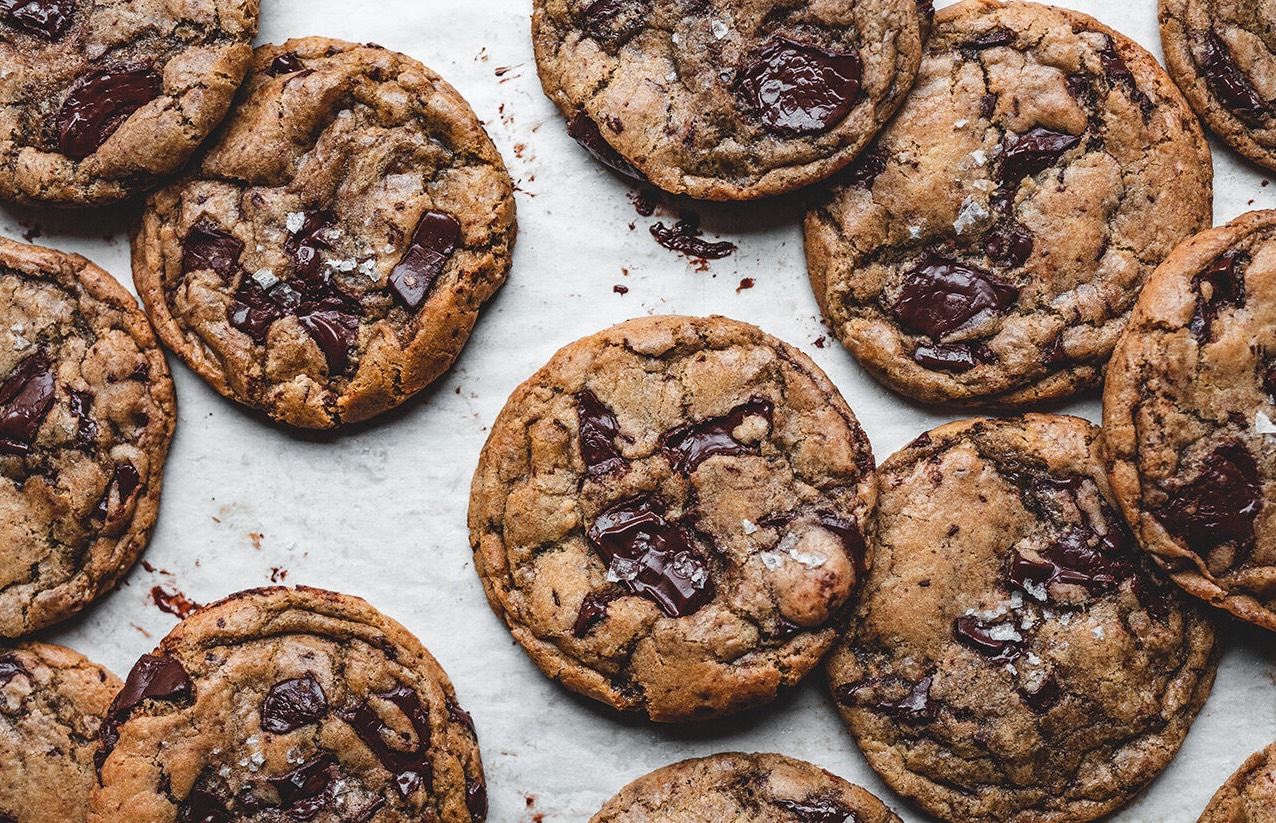 Chocolate chip cookies laying flat on a white background.